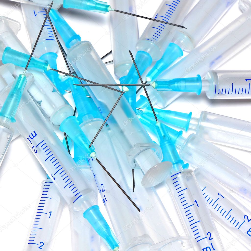 Heap of used disposable syringes