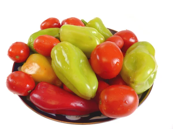 Fresh tomato and pepper on a plate — Stock Photo, Image