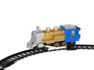 Child's toy, a locomotive on the rails, isolated on a white background clipart