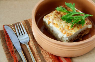 Casserole of macaroni in a clay dish. Greek pastitsio. Lasagna clipart