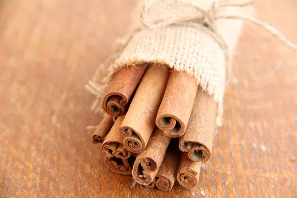 Cinnamon on wooden background — Stock Photo, Image
