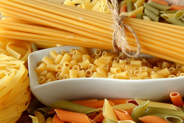 Raw pasta on wood background — Stock Photo, Image