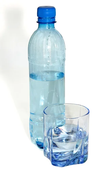 Water in a plastic bottle and a glass glass on a white background — Stock Photo, Image