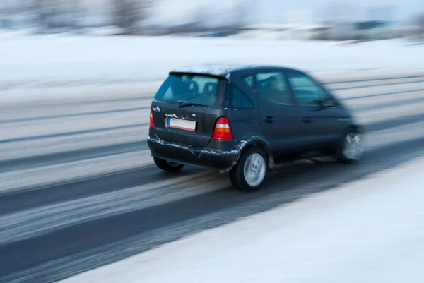 Car moving on snowy road Stock Photo