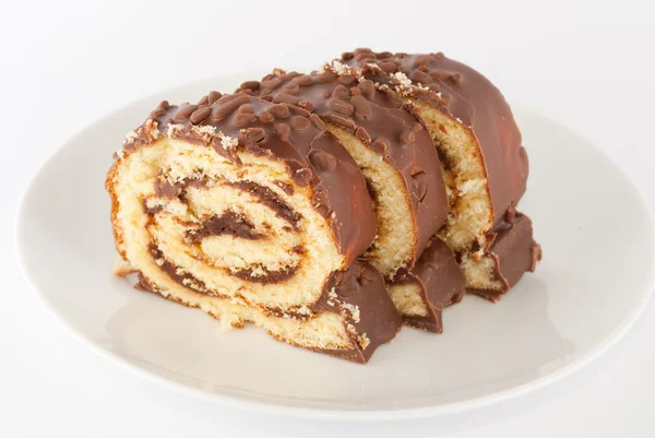 Chocolate swiss roll on a plate Royalty Free Stock Images