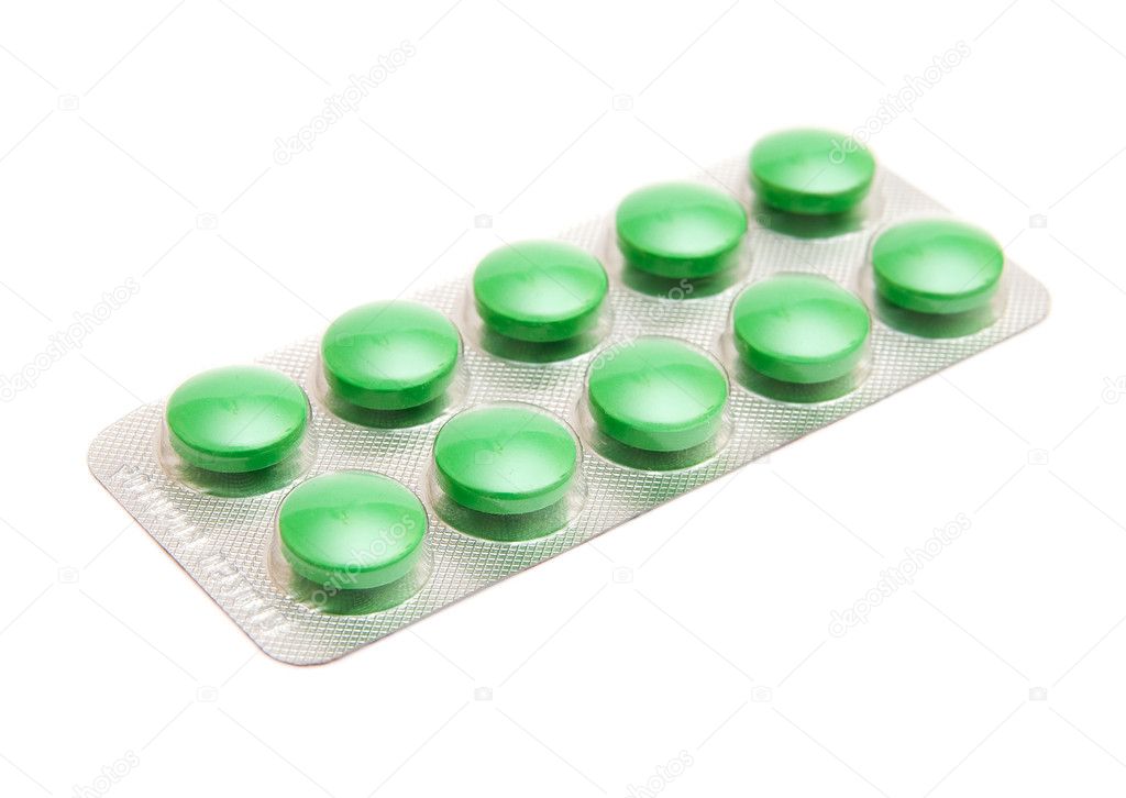 Green pills isolated on white background