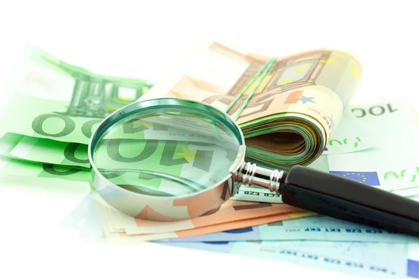 Euro notes with magnifier on white background — Stock Photo, Image