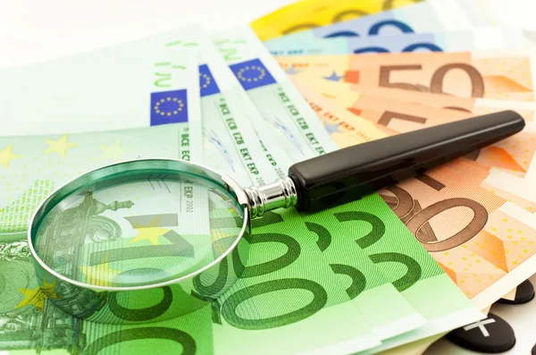 Euro Notes with calculator and magnifier — Stock Photo, Image