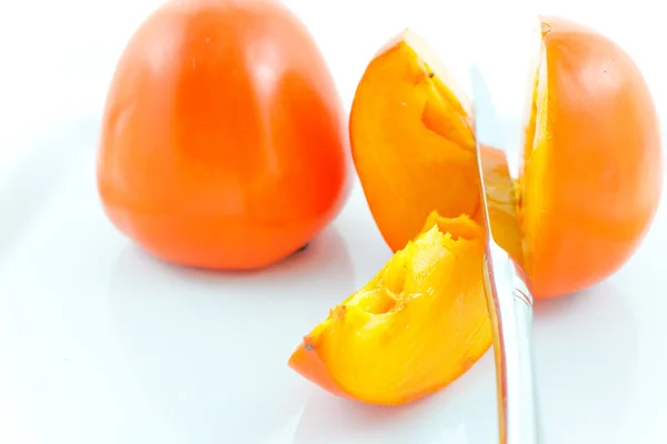 Two ripe persimmons and steel knife — Stock Photo, Image