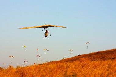 Hang gliding in Crimea taken in summer clipart