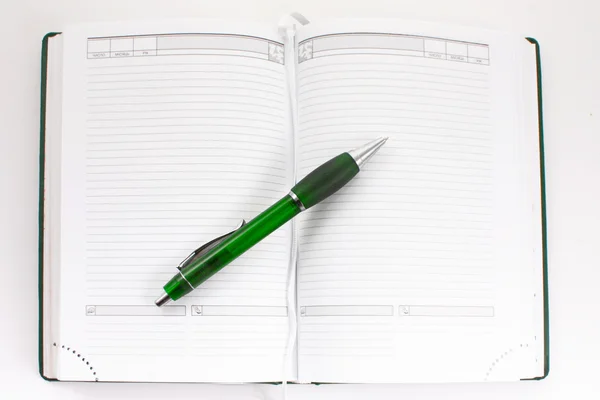 Green notebook and pen — Stock Photo, Image