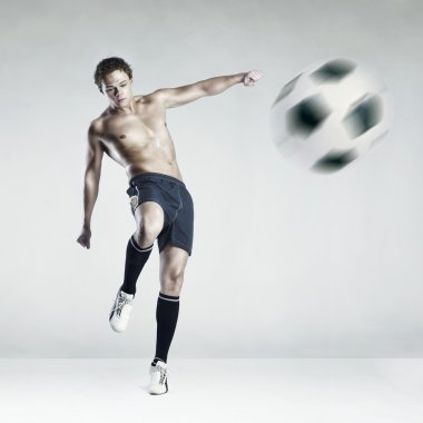 Strong athlete kicking the ball clipart