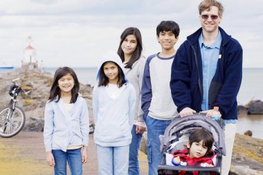 Father with his five children at beach clipart