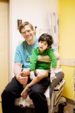 Father and child is doctor's office clipart