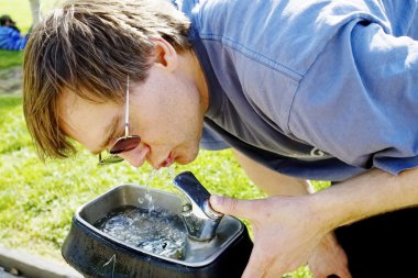 Man drinking water from fountain clipart