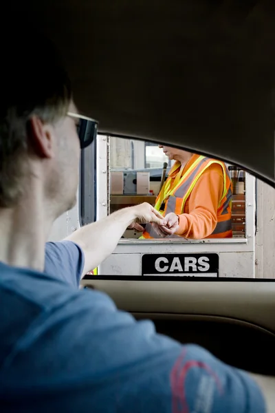 stock image Man paying toll at toll booth