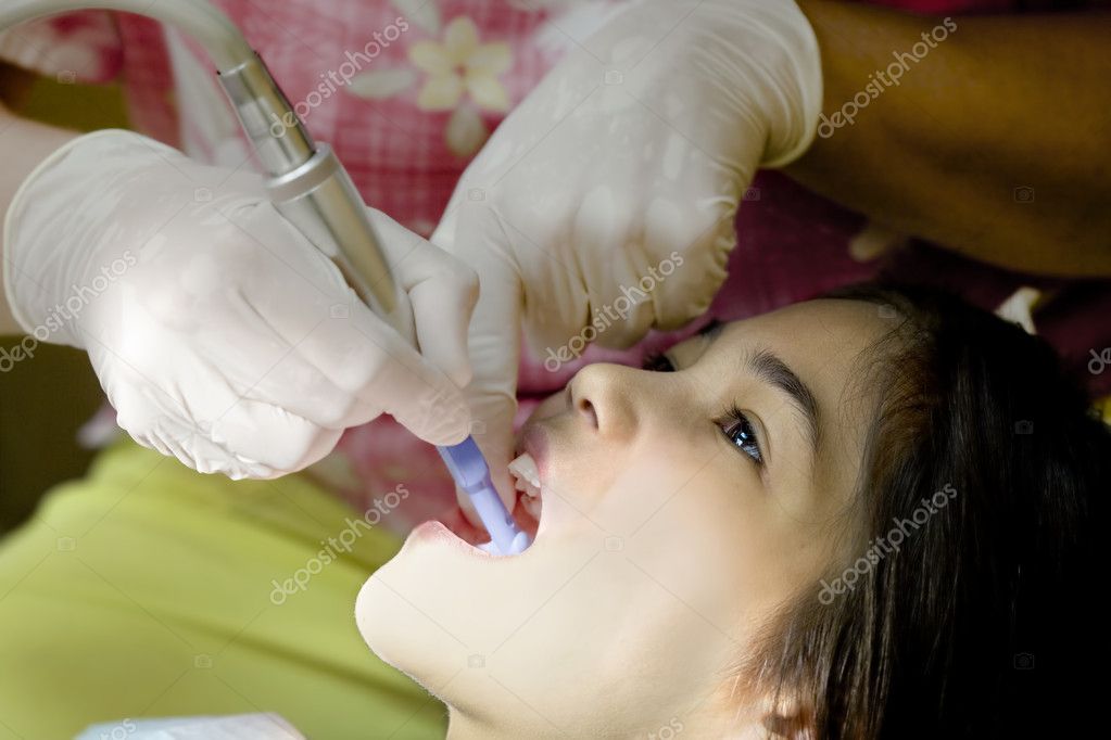 Little girl having teeth cleaned at dental office — Stock Photo