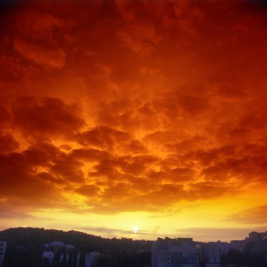 Ominous crimson sunset over a sity. Please see some similar pictures from my portfolio. clipart