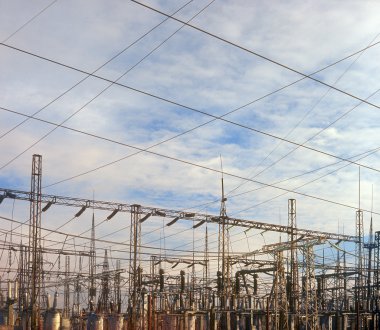 Wires mounted on steel frame at power substation. clipart