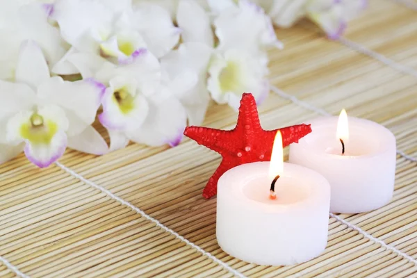 Liting Candles Sea Star Tender Orchids Make Background — Stock Photo, Image