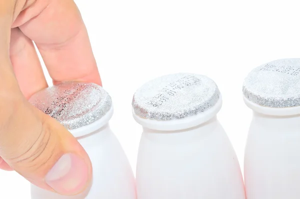 Men`s hand taking a bottle of milk — Stock Photo, Image