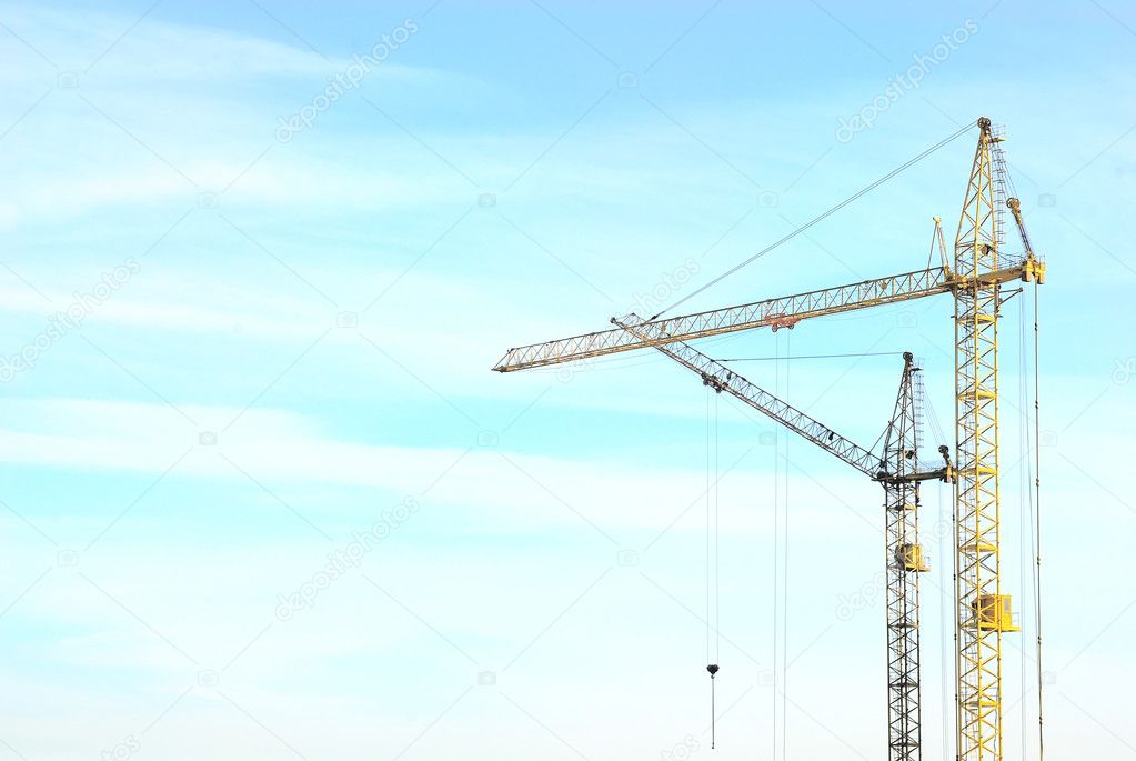 Two cranes over blue sky