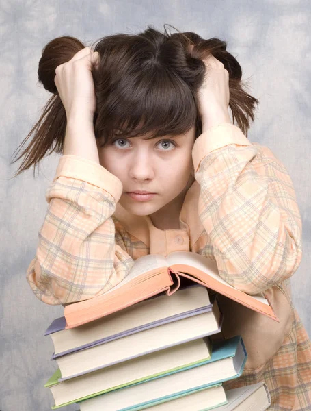 stock image The young girl with books on a light background