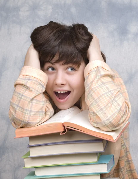 stock image The young girl with books on a light background