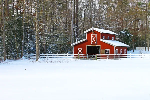 あなたのテキストのための部屋と吹雪の後の雪に覆われた森の中でフィールドの雪に覆われた馬納屋 ストック写真