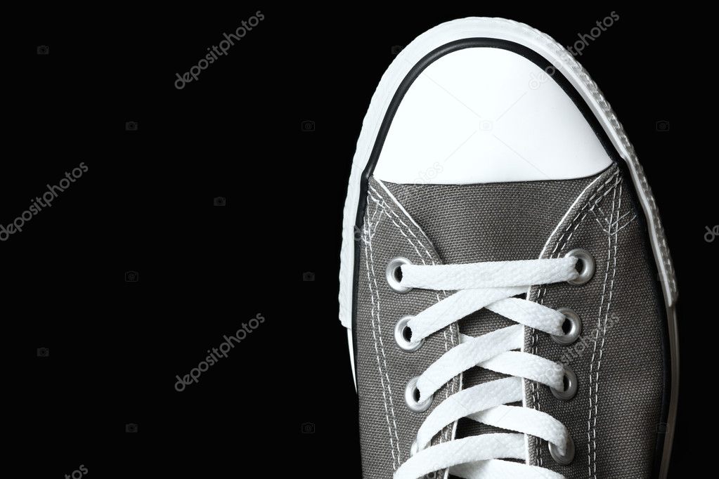 Gray sneakers classic youth footwear at black background — Stock Photo ...