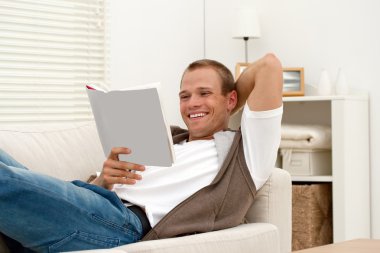 Smiling man reading book clipart