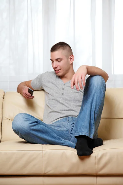 Young Man Using Cell Phone Home — Stock Photo, Image