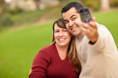 Attractive Mixed Race Couple Taking Self Portraits clipart