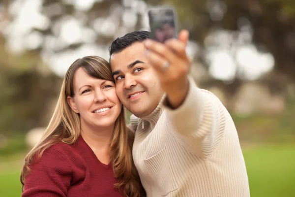 Atractiva pareja de raza mixta tomando autorretratos —  Fotos de Stock