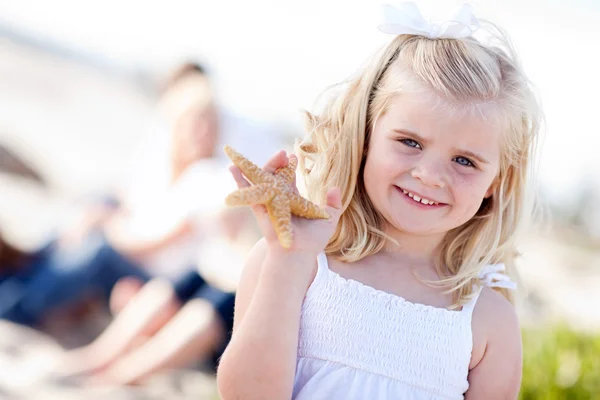 Adorabile bambina bionda con stelle marine — Foto Stock