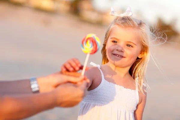 Adorable Little Girl Picking out Lollipop Outside — Stock Photo, Image