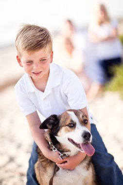 Handsome Young Boy Playing with His Dog clipart