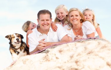 Happy Caucasian Family and Dog Portrait at the Beach clipart