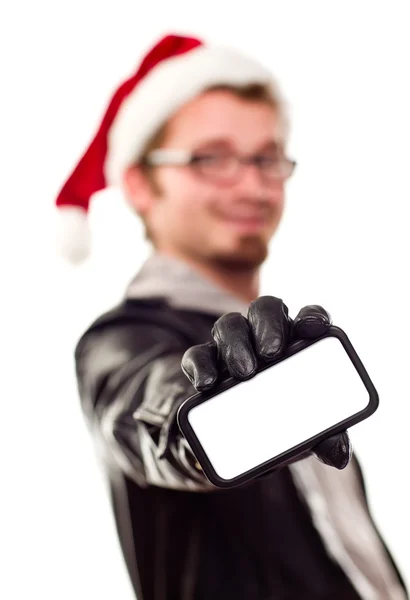 Hombre con sombrero de Santa que sostiene hacia fuera el teléfono celular en blanco — Foto de Stock