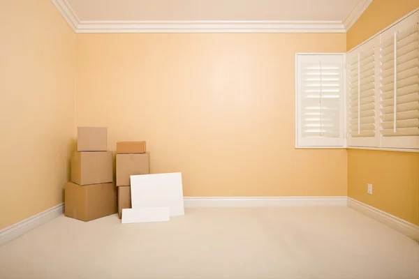 Caixas móveis e sinais em branco no chão no quarto vazio — Fotografia de Stock