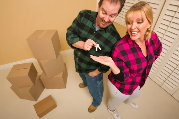 Goofy Excited Man Handing Keys to Smiling Wife — Stockfoto