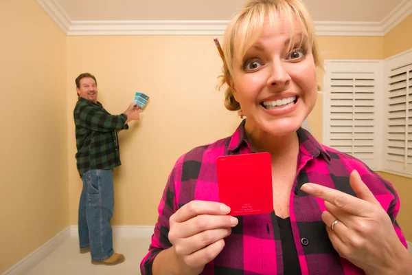 Fun Happy Couple Comparing Paint Colors Empty Room Woman Large — Stock Photo, Image