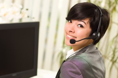 Attractive Young Woman Smiles Wearing Headset clipart