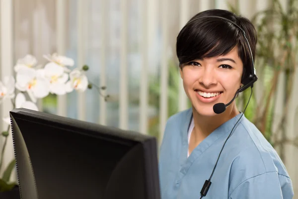 Attractive Multi-ethnic Young Woman Wearing Headset and Scrubs — Stock Photo, Image