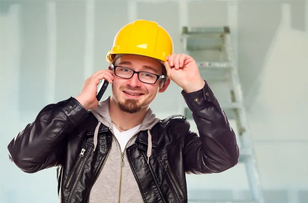 Contractor in Hard Hat on Cell Phone In Unfinished House — Stock Photo, Image
