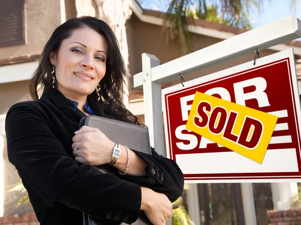 Female Hispanic Real Estate Agent, Sold For Sale Real Esate Sign Stock Image