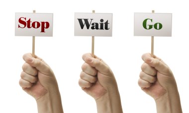 Three Signs In Fists Saying Stop, Wait and Go clipart