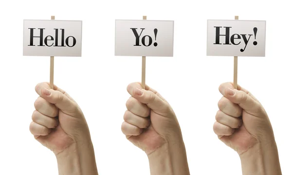 Три знака в кулаках, говорящие Привет, Йо! и Эй ! — стоковое фото