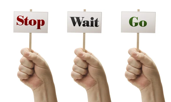 Three Signs In Fists Saying Stop, Wait and Go — Stock Photo, Image