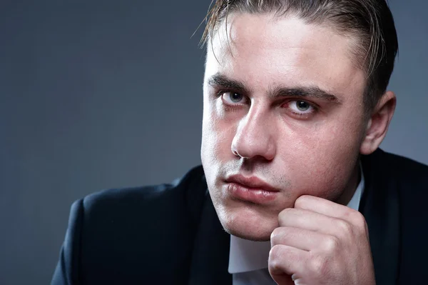Closeup portrait of handsome displeased young man in suit — Stock Photo, Image